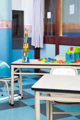 Colorful Construction Blocks And House On Desk