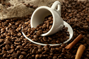 Cup with coffee beans, close up