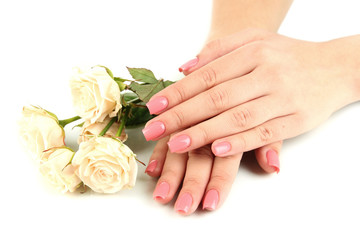 Obraz na płótnie Canvas Woman hands with pink manicure and flowers, isolated on white