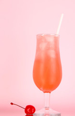 Cherry cocktail with ice on pink background