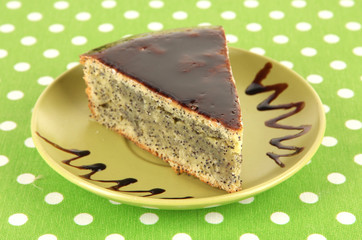Delicious poppy seed cake on table close-up
