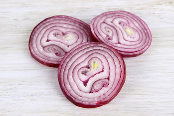 Purple onion on cutting board isolated on white