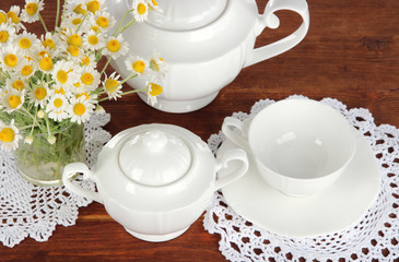 Table setting with chamomiles on wooden table