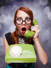 Redhead women with green telephone.