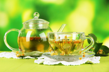 Kettle and cup of tea with linden