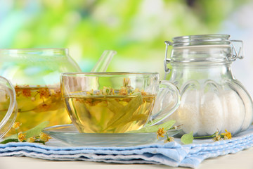 Kettle and cup of tea with linden