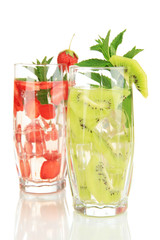 Glasses of fruit drinks with ice cubes isolated on white