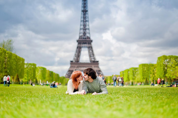 Naklejka premium Loving couple kissing near the Eiffel Tower in Paris