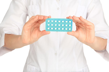 Hormonal pills in hands of doctor isolated on white