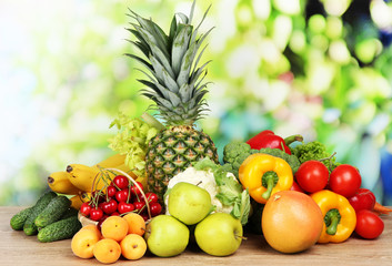 Assortment of fresh fruits and vegetables on natural background