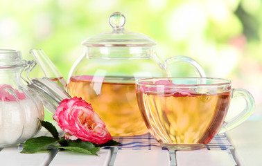 Kettle and cup of tea from tea rose