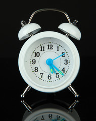 Old style alarm clock isolated on black