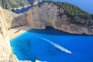 beautiful white beach with shipwreck in a greek island