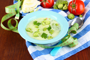 Cabbage soup in plates on napkin on wooden table
