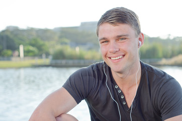 Fototapeta premium Handome teen smiling with earphones on