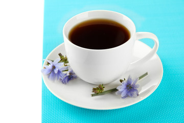 Cup of tea with chicory, isolated on white