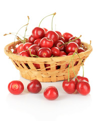 Cherry berries in wicker basket isolated on white