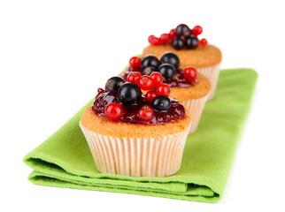 Tasty muffins with berries isolated on white