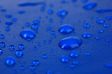 Water drops on blue plastic background