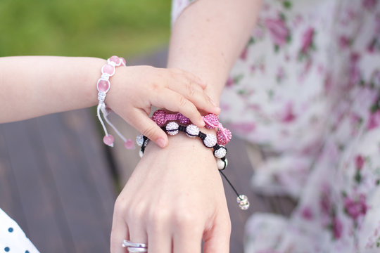 mother and daughter are holding their hands