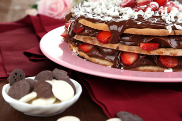 Chocolate cake with strawberry on wooden table close-up