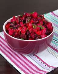 Beet salad in bowl on table close-up