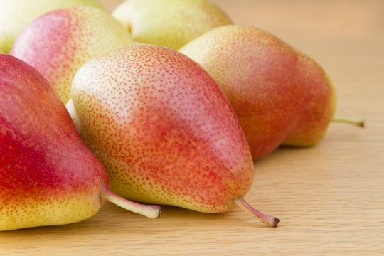 Close up image of forelle pears on wooden table
