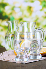 Glass pitchers of water and glasses