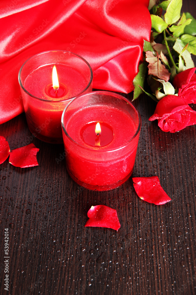 Wall mural Beautiful romantic red candle with flowers, close up