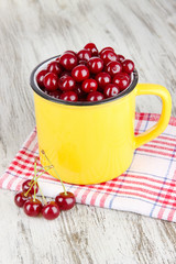 Sweet cherry in cup on table close-up