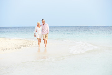 Romantic Senior Couple Walking On Beautiful Tropical Beach
