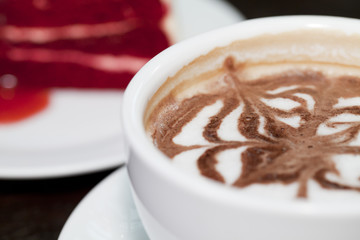 Cappuccino cup coffee with red berry cheesecake