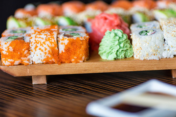 Sushi rolls served on a wooden plate