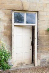 Fototapeta na wymiar Old external door in a stone wall