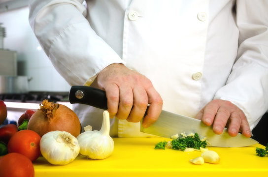 Chef hands cutting vegetables