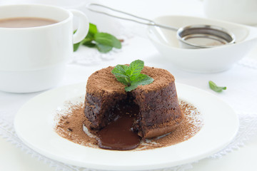 Chocolate dessert fondant with a liquid center and strawberries.