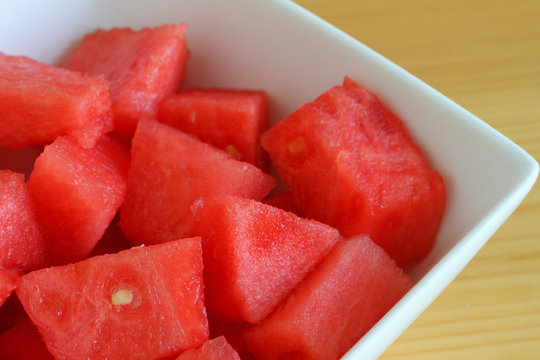 Watermelon cubes in white bowl, close up