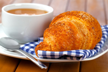 Fototapeta na wymiar Croissant with marmalade and caffee cup. on wooden backgroun