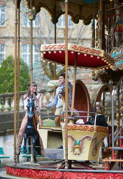 Couple having fun on merry-go-round