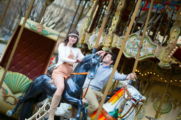 Couple having fun on merry-go-round