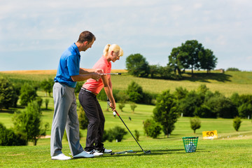Young female golf player on course