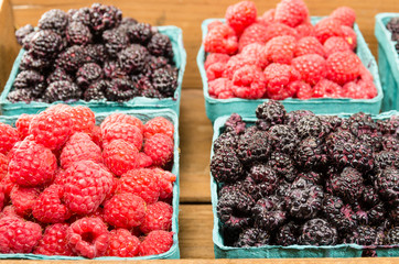 Wooden box with baskets of berries