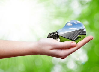 Bulb with of solar panel in hands