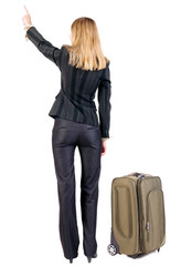 Back view of  pointing business woman with suitcase looking up.