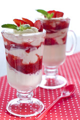 Dessert with fresh strawberries with whipped cream and mint