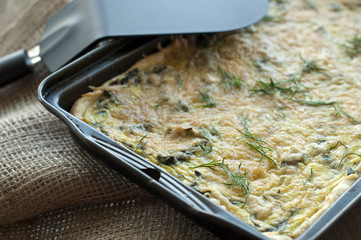tasty quiche with spinach and parmesan in the pan