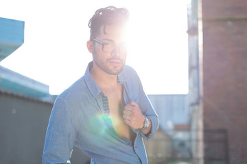casual man in front of shiny sun
