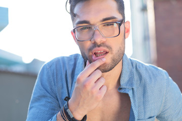 casual man touches his lower lip