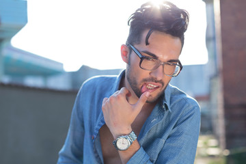 casual man with hand on lip