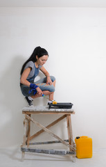 Capable woman painting the wall of her house